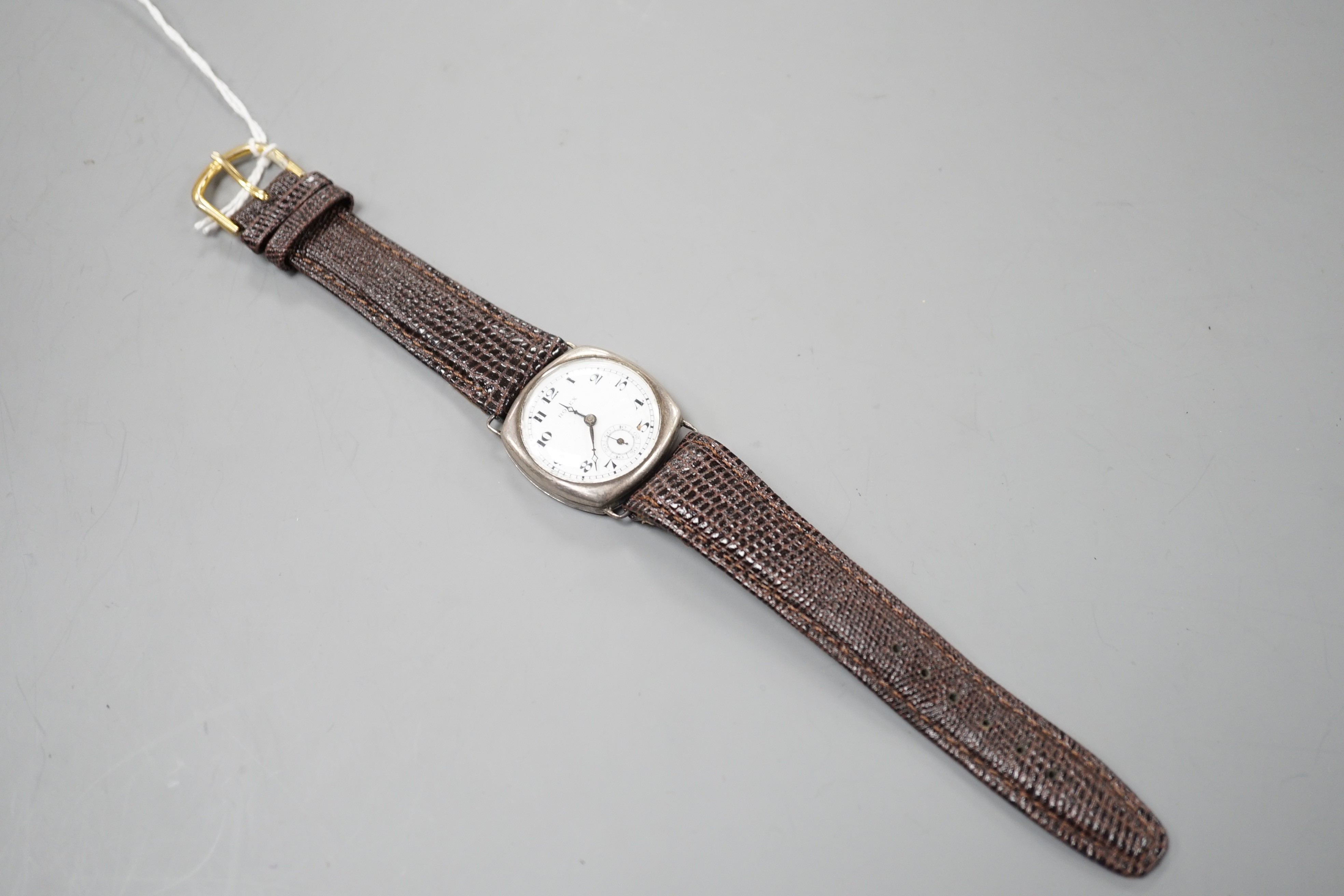 A gentleman's 1920's silver wrist watch, with Arabic dial and subsidiary seconds, the dial signed Rolex, movement unsigned, lacking winding crown.